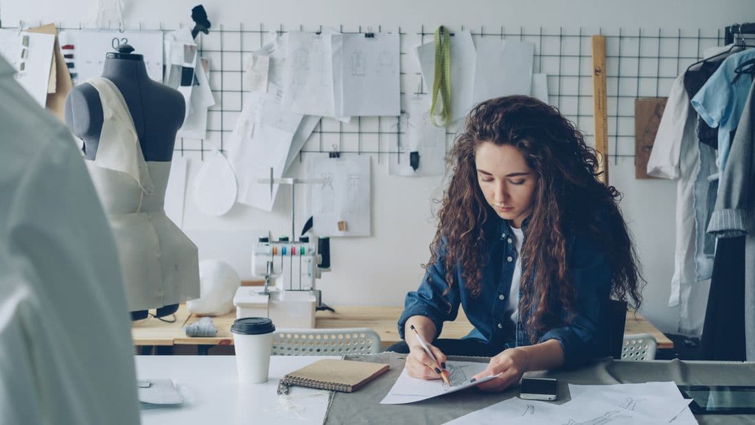 Designer developing a garment brief in a studio